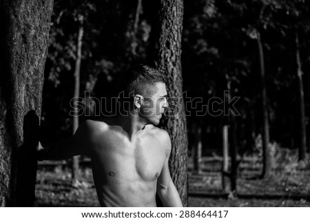 Man photographed in street workout session.Photo was taken in early morning, around 6am in city park Dudova forest. Black and white photo.