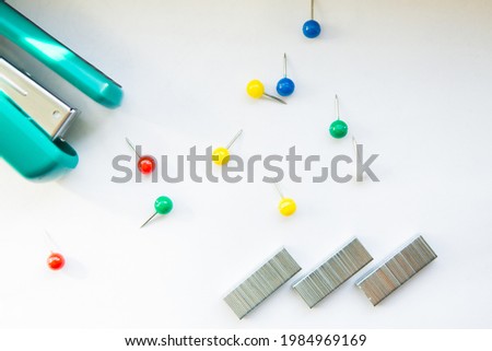 Stationery buttons, staples and stapler on white background Photo stock © 