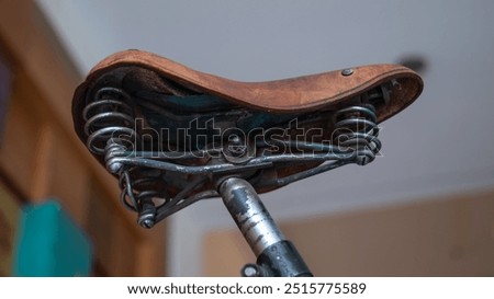 Similar – Image, Stock Photo Old bicycle saddle with visible springs and rust