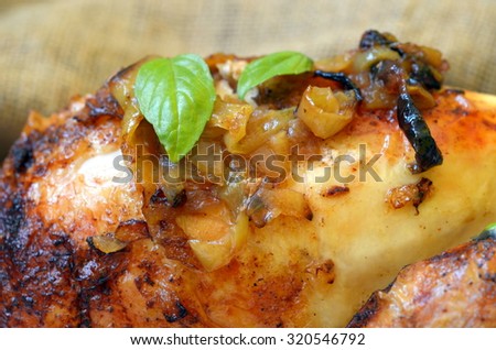 Roasted chicken with herbs and rice on wooden background