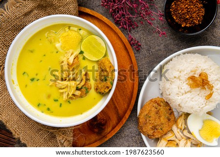 Nasi Soto Ayam or Soto Medan is  Traditional chicken soup with rice from Medan, North Sumatra. 

Soto is a traditional Indonesian soup mainly composed of broth, meat, fried patties and vegetables. 商業照片 © 