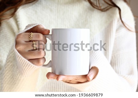 Similar – Image, Stock Photo Woman holding a cup of hot chocolate with marshmallows.