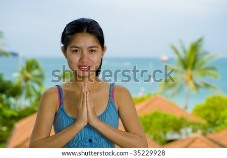 beautiful young asian woman with welcome expression in front of the sea