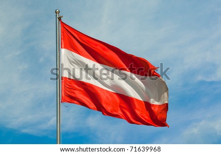 austrian flag on a pole over beautiful sky