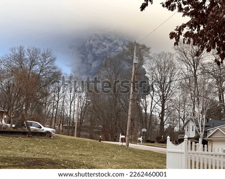 The rising smoke cloud after authorities released chemicals from a train derailment as seen from the ground in a nearby neighborhood. Photo credit: RJ Bobin. Stock foto © 