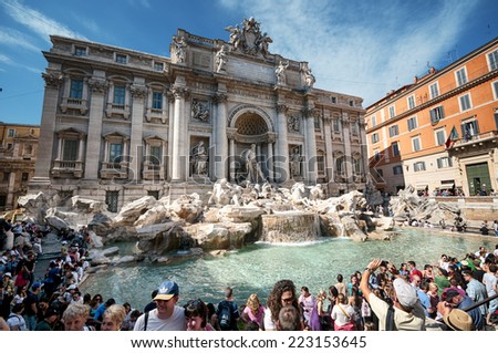 ROME, ITALY - MAY 12, 2012: Tourists visiting the Trevi Fountain. Trevi Fountain is an iconic symbol of Imperial Rome. It is one of Rome\'s most popular tourist attractions.