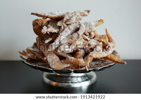 Faworki (angel wings), sprinkled with powdered sugar, brushwood, kerchief, chrissy, crepe.Traditional, Polish carnival delicacy. Crisp cake with a sweet taste, in the shape of a complex bow.
