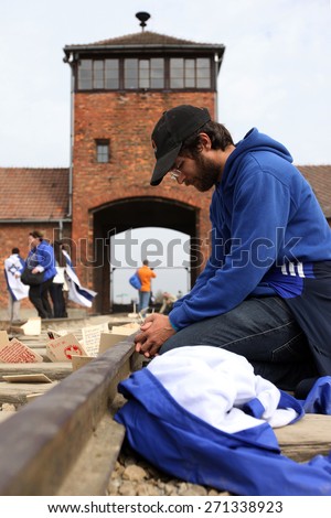 OSWIECIM, POLAND - APRIL 16, 2015: Holocaust Remembrance Day next generation of people from the all the world meets on the March of the Living in German death camp in Auschwitz Birkenau, in Poland