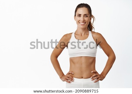 Similar – Image, Stock Photo Attractive sportswoman standing and listening music on the street