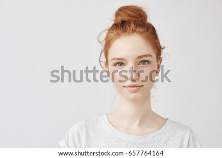 Similar – Image, Stock Photo Young beautiful red head looking serious to camera hipster woman .Trendy girl in summer T-shirt and black jeans .Serious and pensive female posing in the street near a brick wall.