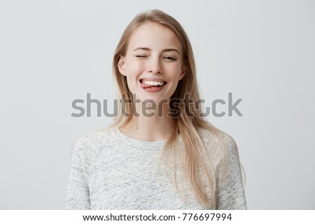 Similar – Image, Stock Photo Playful trendy woman on street in sunshine covering camera with hands