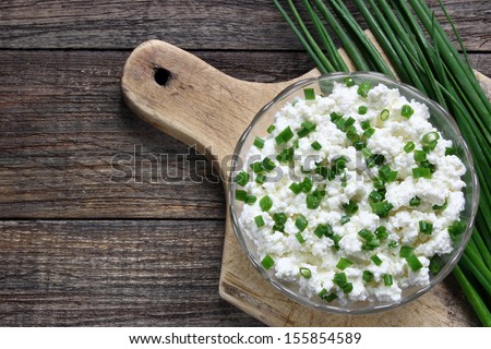 Cottage cheese with chives in glass bowl