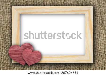 Two hearts and frame on old canvas
