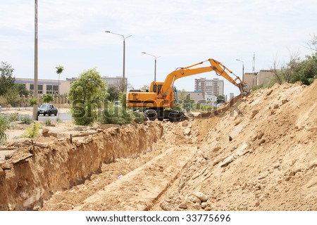 Excavators dig trenches for the repair of heating pipes.