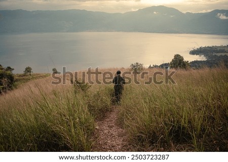 Similar – Image, Stock Photo A man walks through the green forest