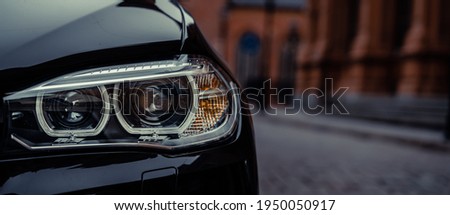Modern car headlight close up photo