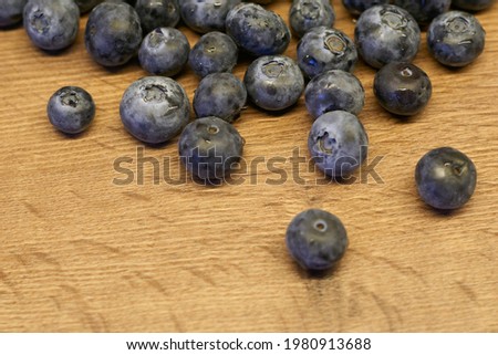 Natural wooden background. Food background. Blueberries ripe and tasty on a wooden table. A large plan, a top view, rustic style. Stok fotoğraf © 