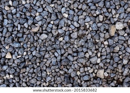 Smooth round pebbles texture background. Pebble sea beach close-up, dark wet pebble and gray dry pebble. High quality photo
