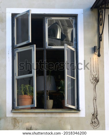 open window, flowers and a floor lamp inside . High quality photo Imagine de stoc © 