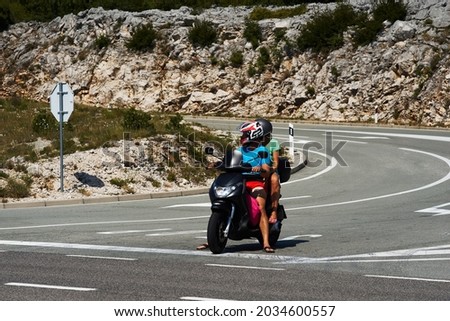 couple on a scooter stand on the road background of mountains. High quality photo
