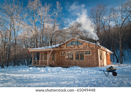a small wooden house in a snowy forest