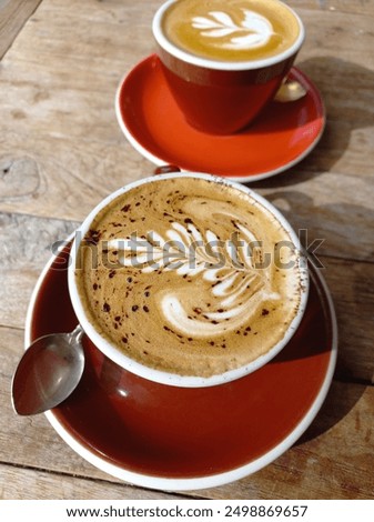 Similar – Image, Stock Photo Cappuccino with latte art on a wooden table in a cafe