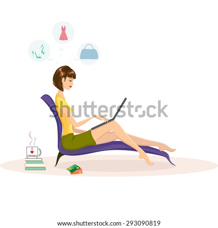 Internet shopping concept, fashion shopping. Woman on a couch with laptop on her knees and shopping online. Mug with words I love dresses on it standing near the couch. Two credit cards lying near by