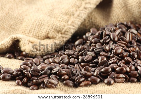 Open canvas bag with fallen out coffee beans