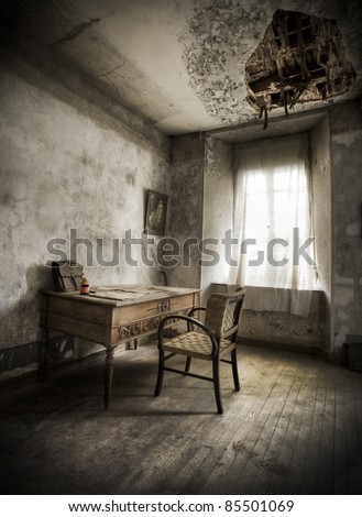 A desk in a creepy atmosphere, broken ceiling and moody light.