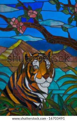 Colorful stained glass with a tiger behind palm leaves on Hawaii island
