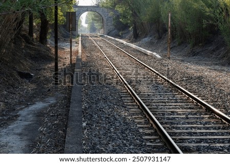 Similar – Foto Bild Gegenlichtlandschaftsbild mit Brücke, Fluss und Strommast