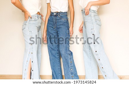 Similar – Image, Stock Photo Three legs in jeans and sneakers, standing on the street in confetti, at carnival.