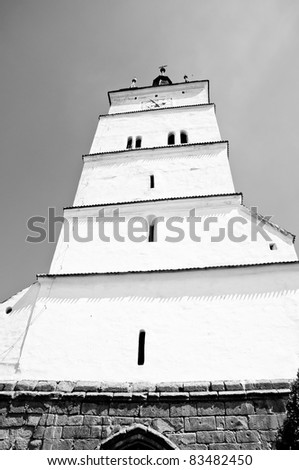 Tall white tower of a saxon fortified church in Romania