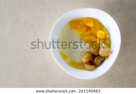 tofu pudding jelly topping fruits salad and syrup on wood table, clean food
