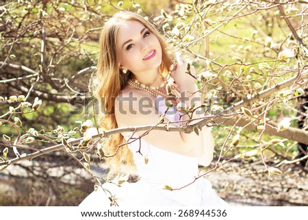 Young beautiful blonde bride with pearls magnolias