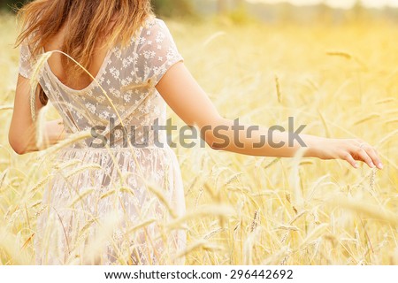 Natural beauty. Beautiful girl in a wheat field