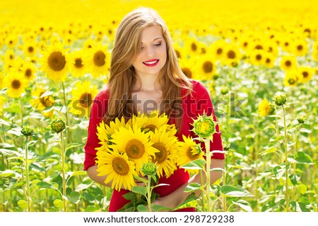 Girl in sunflowers in the red dress