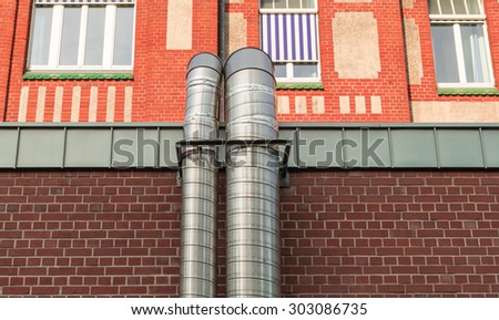 Exhaust pipes of metal of an old factory of bricks