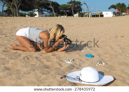 Photographer at work, jewelry photography on the beach.