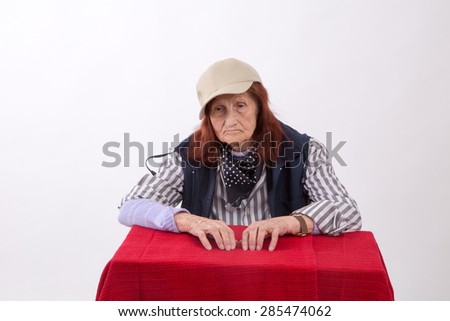 Portrait of an elderly woman with sad face expression.