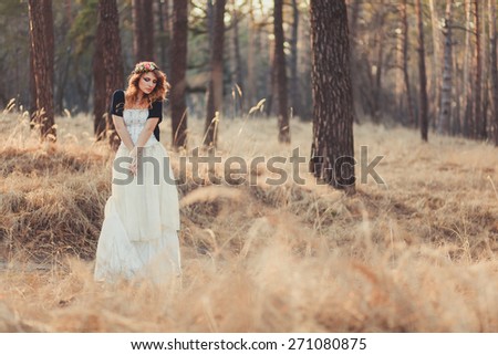 Beautiful Red Hair bride outdoors in a forest