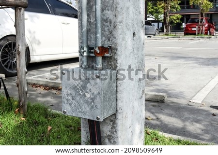 Electrical metal box installed under a concrete electric pole. Used to connect to electrical conduits. To prevent leakage current for safety. Foto stock © 