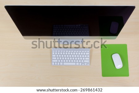 Office computer, keyboard and mouse on wooden table