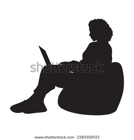  Curly hair woman with laptop sitting on bean bag silhouette.
