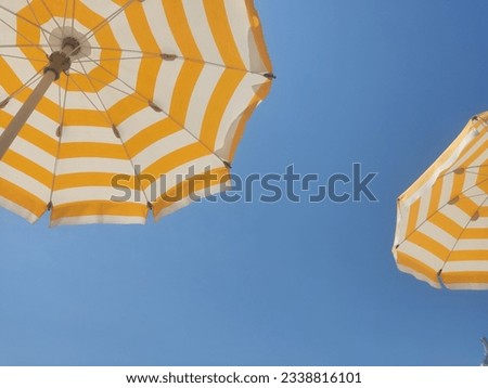 Similar – Foto Bild Gelber Sonnenschirm vor blauem Himmel. Sommer und Urlaub.