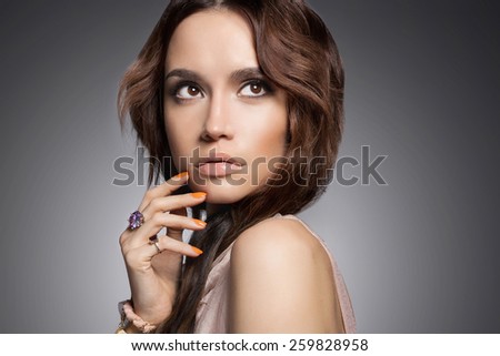 Fashion studio photo of beautiful lady with jewelry.Young woman
