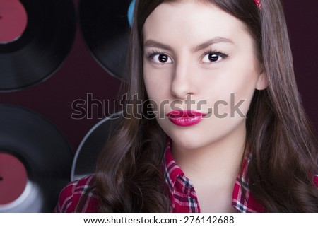 Close-up portrait of beautiful Young woman.simple girl in shirt.vinyl background