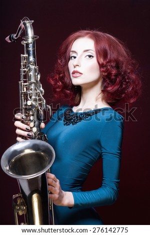 beautiful girl with saxophone.young sexy woman play sax.musical instrument.jazz