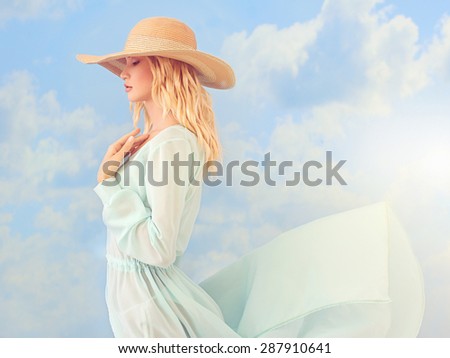 beautiful young woman in hat.summer girl in blue dress