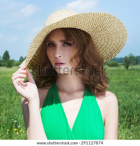 beautiful young woman in hat on the field.summer girl